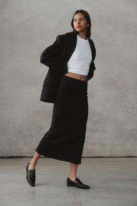 vegan leather loafers worn with a black skirt